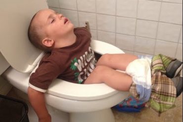 Boy Sleeping In Toilet