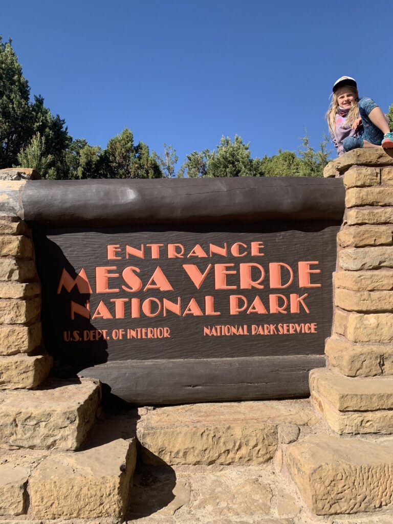 A child on the sign for Mesa Verde National Park