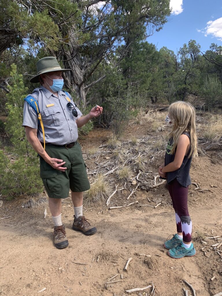 A ranger and the author's daughter speak about Mesa Berde National Park