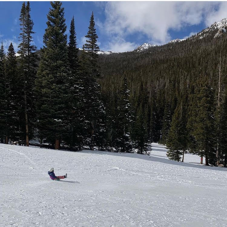 A child sleds down Hidden Valley Hill in Rocky Mountain National Park